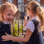 Two young primary school girls laughing together in the playground.