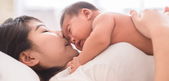 Baby On Chest Of Woman