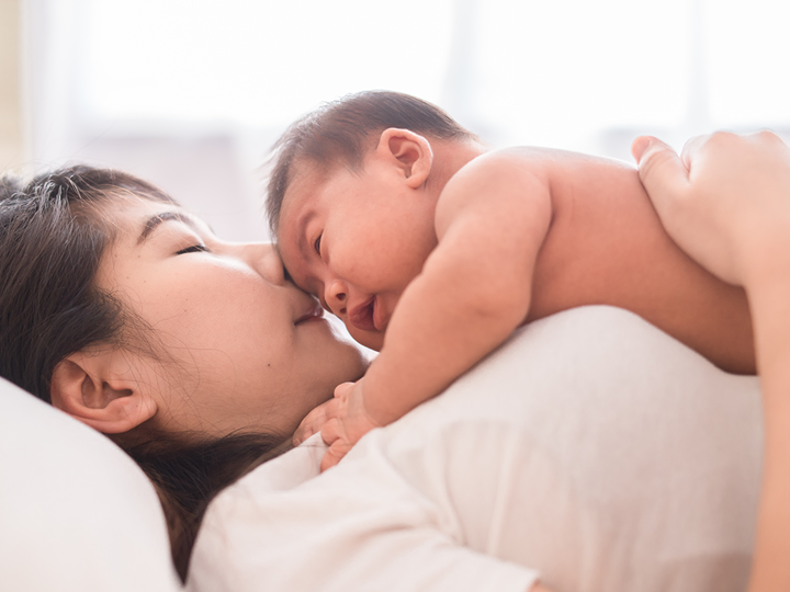 Baby On Chest Of Woman