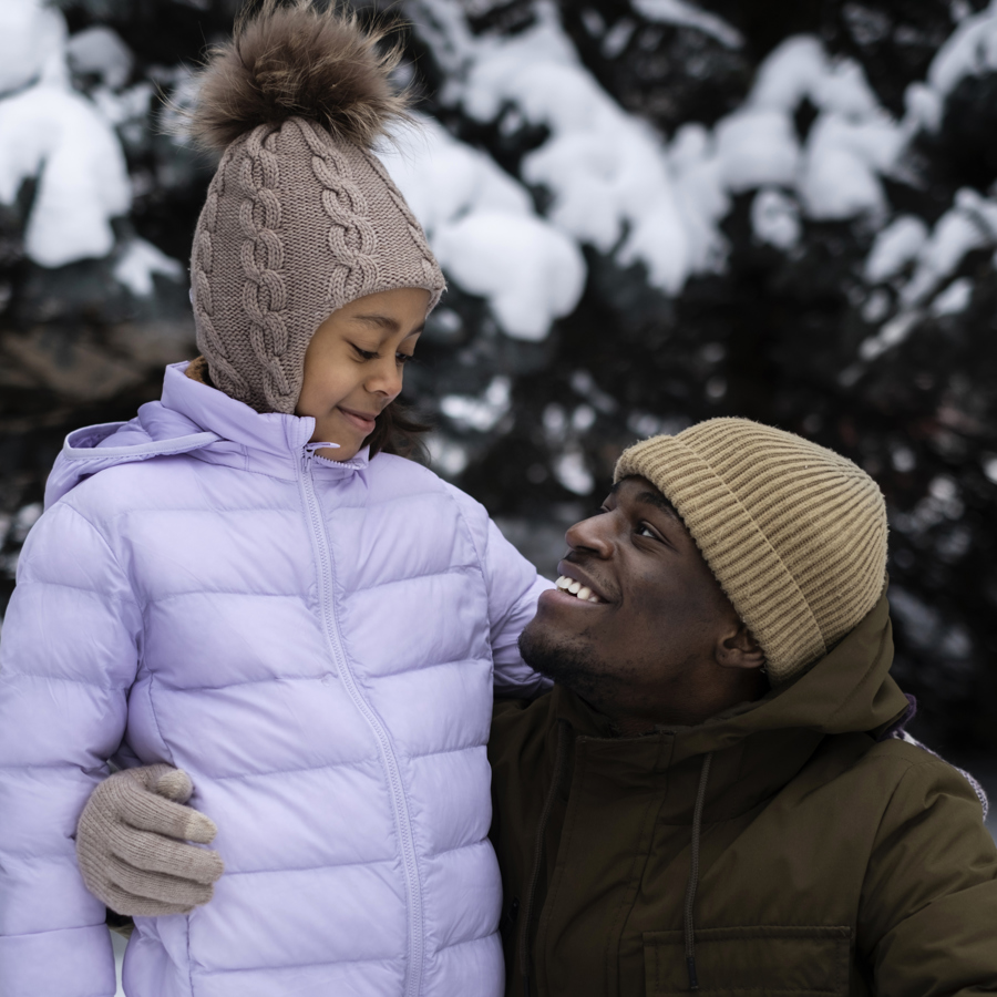 Young Girl Enjoying Winter Day Outdoors With Her Father