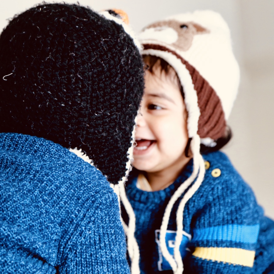 Boy Wearing Knit Hat With Brother