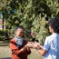 adult woman and teenage boy playing hand slap game outdoors