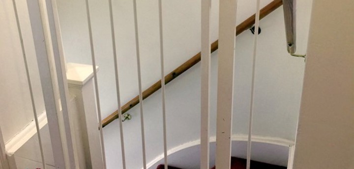 Stair gate in a home at the top of the stairs