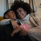 Mother giving son present at home