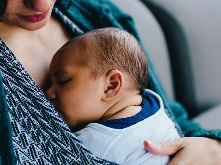 Close up of adult woman holding baby